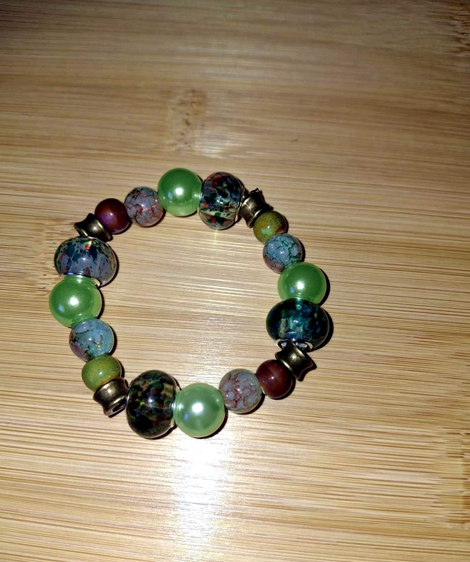 Sage Green Mixed-Bead Bracelet: Green, turquoise, bronze, and soft earth-tone bracelet with mixed glass, resin, and metal bead accents.